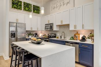 Tuxedo white and blue cabinetry in select homes